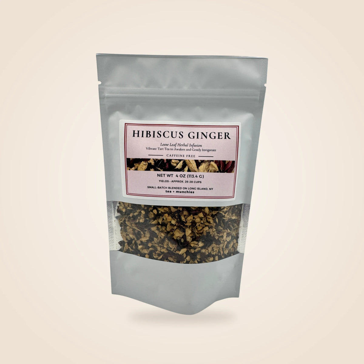 A white stand-up pouch of Hibiscus Ginger herbal supplement with a clear window showing the dried flower and ginger blend inside, set against a solid light beige background.