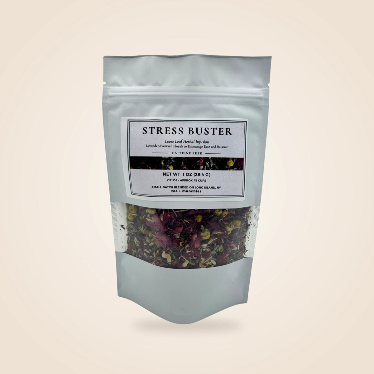 A white stand-up pouch of 'Stress Buster' herbal tea with a clear window showing dried flowers and leaves inside, set against a solid light beige background.
