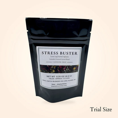 A black stand-up pouch of Stress Buster loose leaf herbal infusion tea by tea + munchies, shown on a light beige background with 'Trial Size' text in the bottom right corner.
