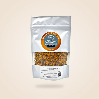 A white stand-up pouch of Turmeric Cinnamon herbal tea by tea + munchies, featuring a clear window showing the golden-brown herbal blend inside, set against a solid beige background.