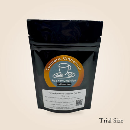 A black resealable stand-up pouch of tea + munchies Turmeric Cinnamon herbal tea, shown on a plain light beige background with the words 'Trial Size' in the bottom right corner.