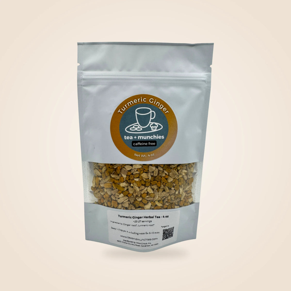 A white stand-up pouch of Turmeric Ginger Herbal Tea by tea + munchies, featuring a clear window showing the loose herbal tea blend inside, set against a solid light beige background.
