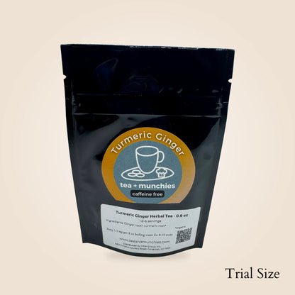 A black stand-up pouch of Turmeric Ginger Herbal Tea by tea + munchies, shown on a light beige background with 'Trial Size' text in the bottom right corner. 