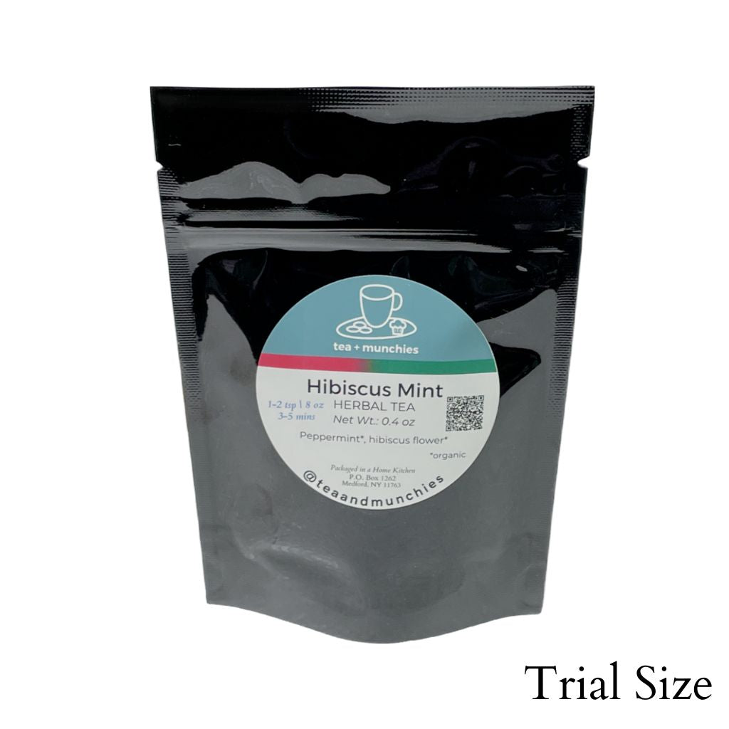 Resealable black glossy stand-up package of trial size loose leaf hibiscus mint herbal tea on white background. 'Trial size' written in lower right hand corner | tea + munchies