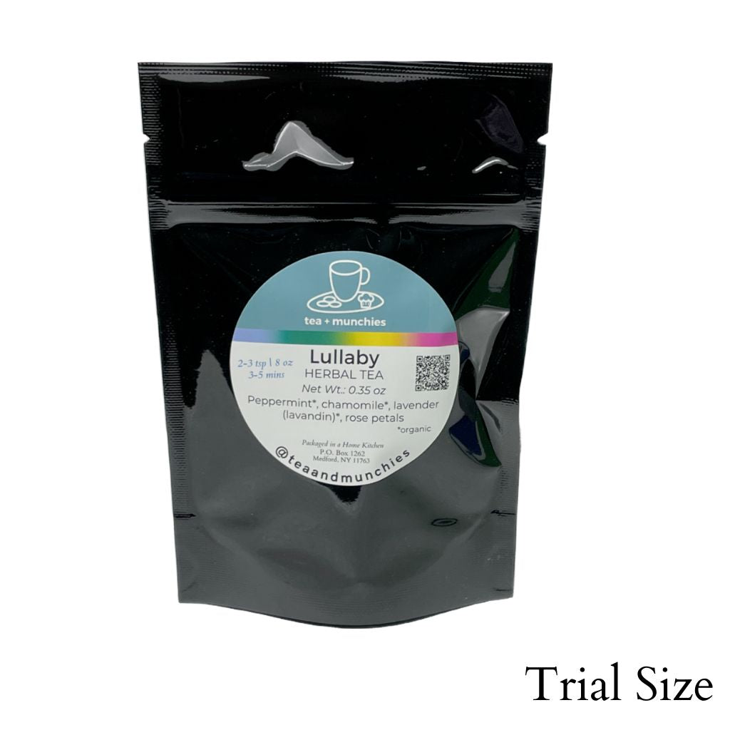 Resealable black glossy stand-up package of trial size loose leaf lullaby herbal tea on white background. 'Trial size' written in lower right hand corner | tea + munchies