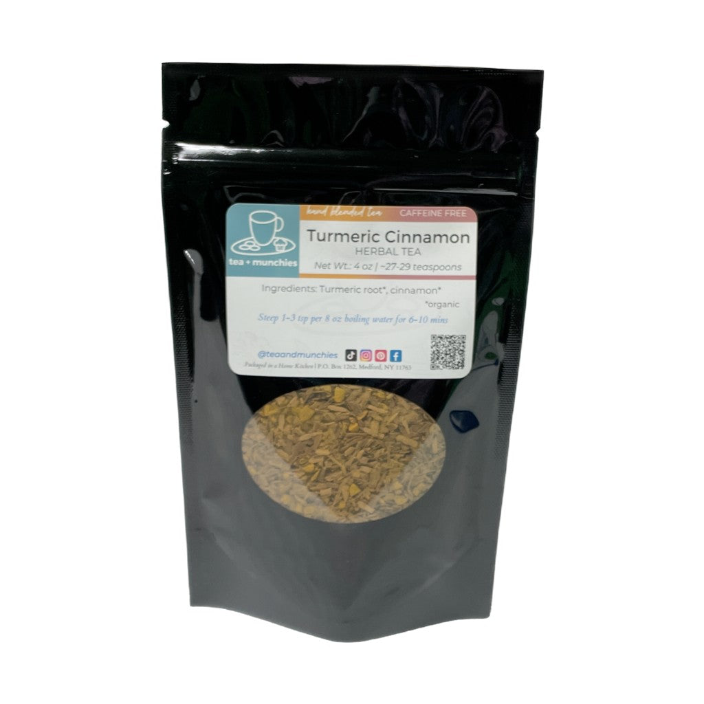 Resealable black glossy stand-up package of loose leaf turmeric cinnamon herbal tea on white background | tea + munchies