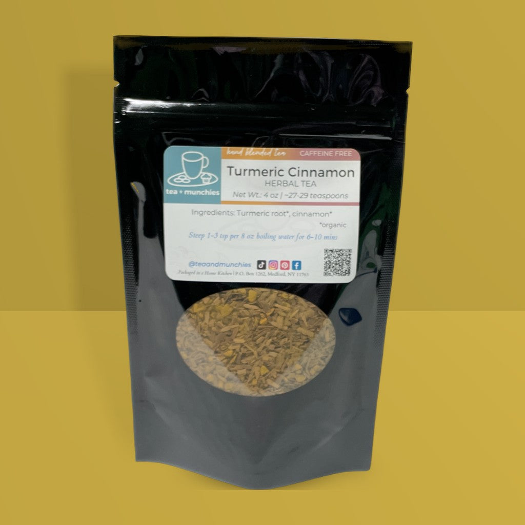 Resealable black glossy stand-up package of loose leaf turmeric cinnamon herbal tea on dark yellow background | tea + munchies